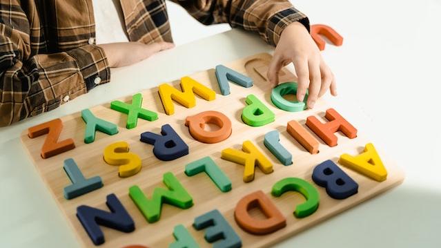 Child playing with Alphabet puzzle